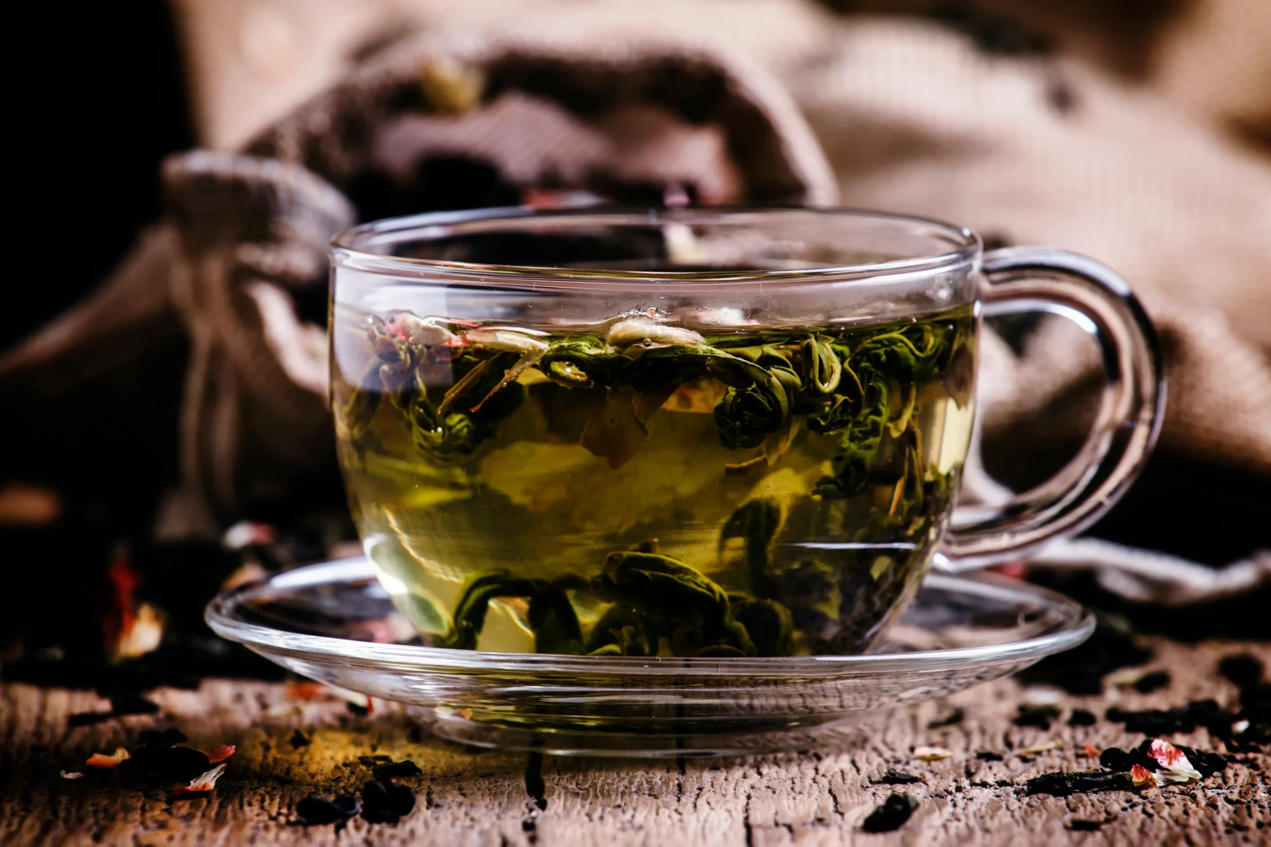 cup of green tea with flower petals